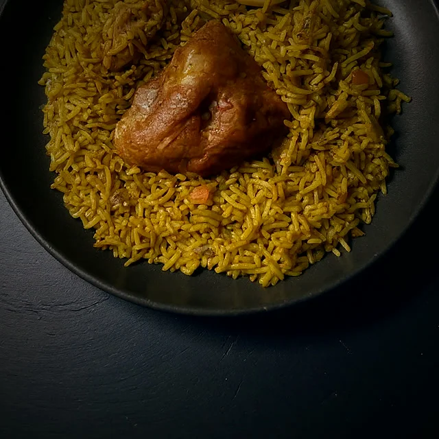 Sri Lankan chicken biryani with turmeric-gold rice and a spiced fried piece