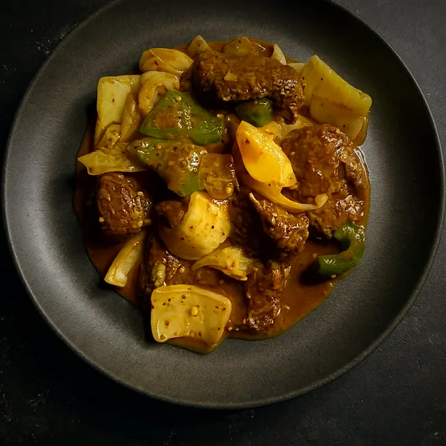 Devilled chicken in glossy red sauce with peppers