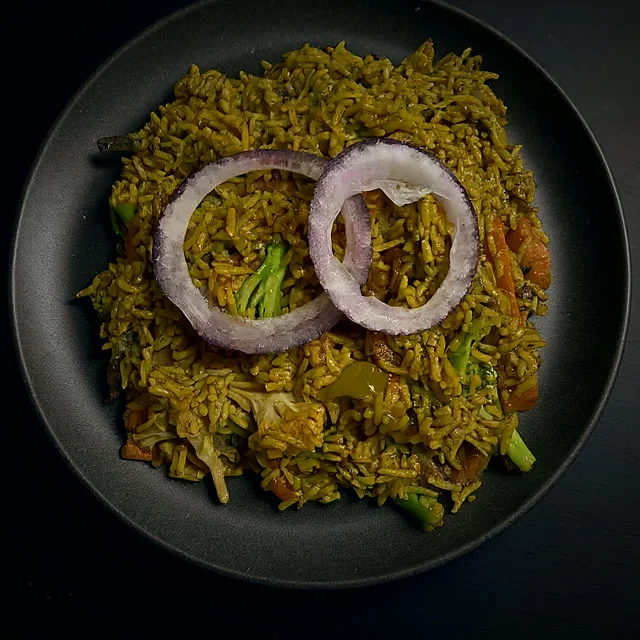 Fried rice with vegetables and red onion rings