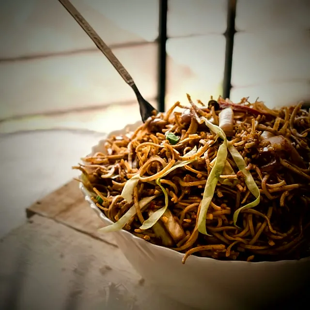 Wok-fried noodles tossed with shredded vegetables