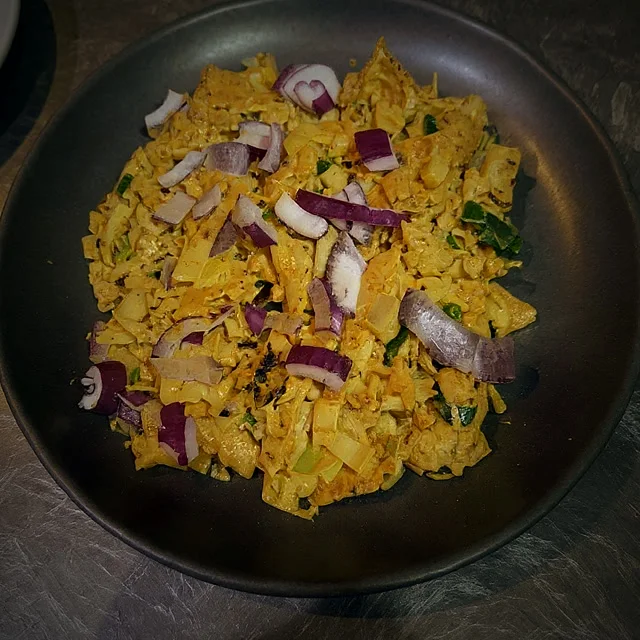Kothu rotti topped with fresh red onion